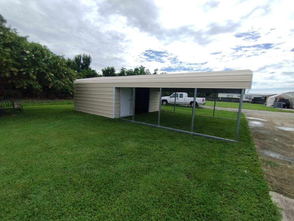 Tan metal carport with enclosed storage room, roll-up door, and parked pickup truck